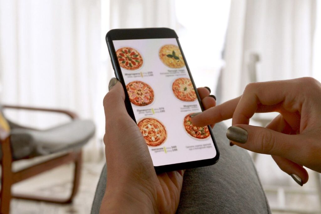 Customer placing an online order for pizza using online payments